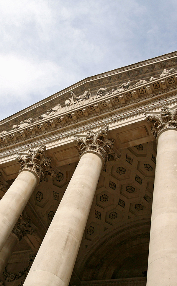 Close-up view of a courthouse with tall columns.